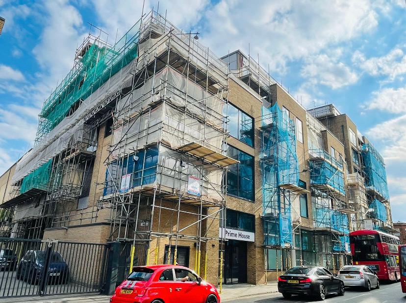Prime House commercial facade with netted scaffold